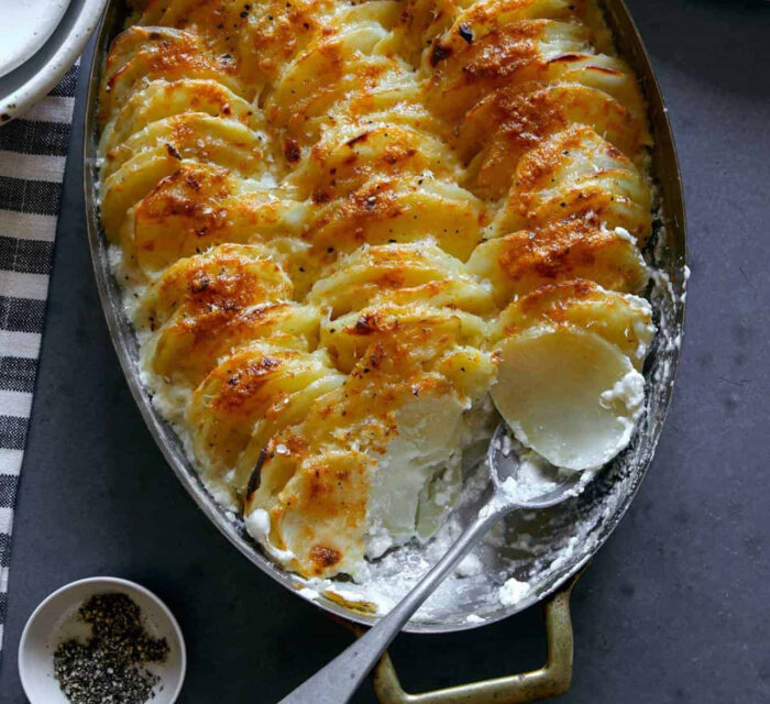 gratin de pommes de terre avec cuillère dans un plat au four