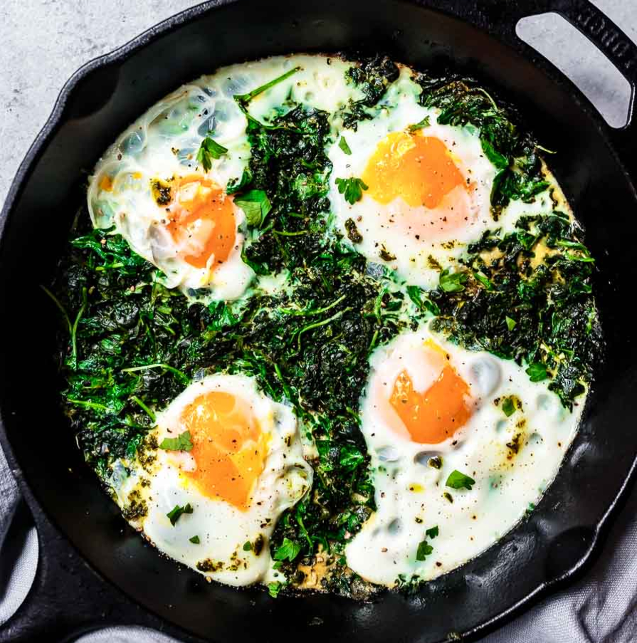 Des œufs avec des légumes cuits ensemble dans une poêle noire