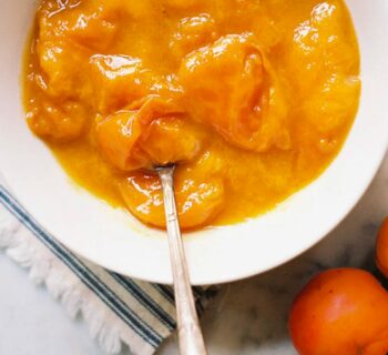 Compote d'abricot servie dans un bol blanc avec une cuillère