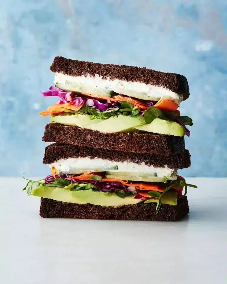 Sandwich veggie pique-nique avec de l'avocat, concombre, boursin et carotte et chou rouge.