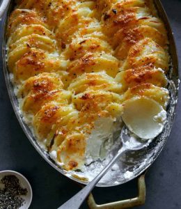 gratin de pommes de terre avec cuillère dans un plat au four